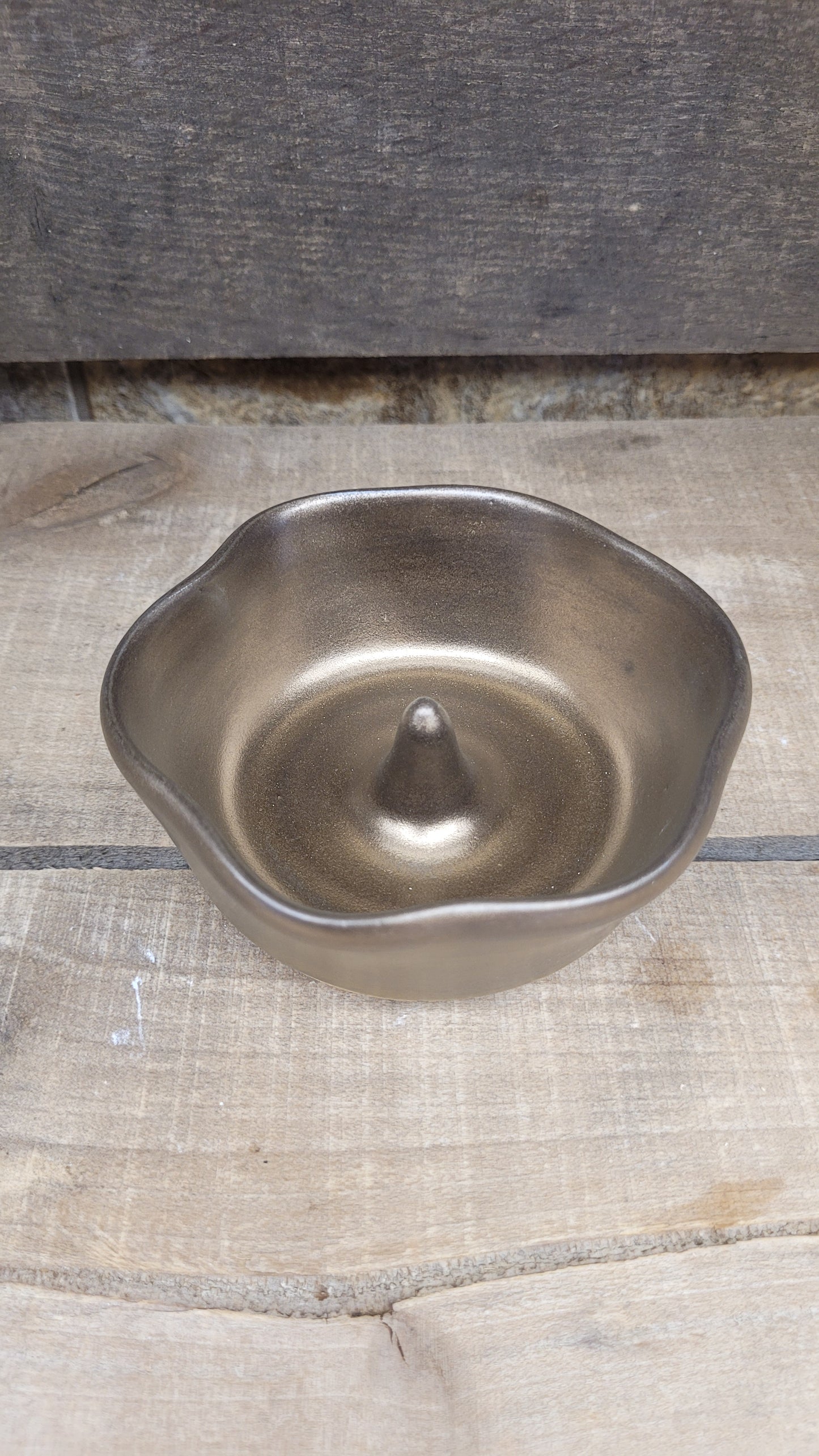 Gold ring dish on wood surface