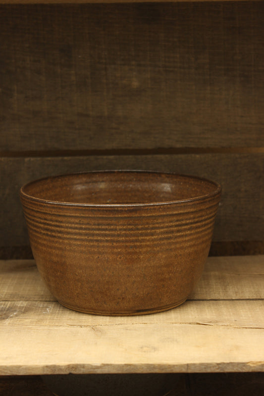 Brown ceramic bowl on a wooden surface