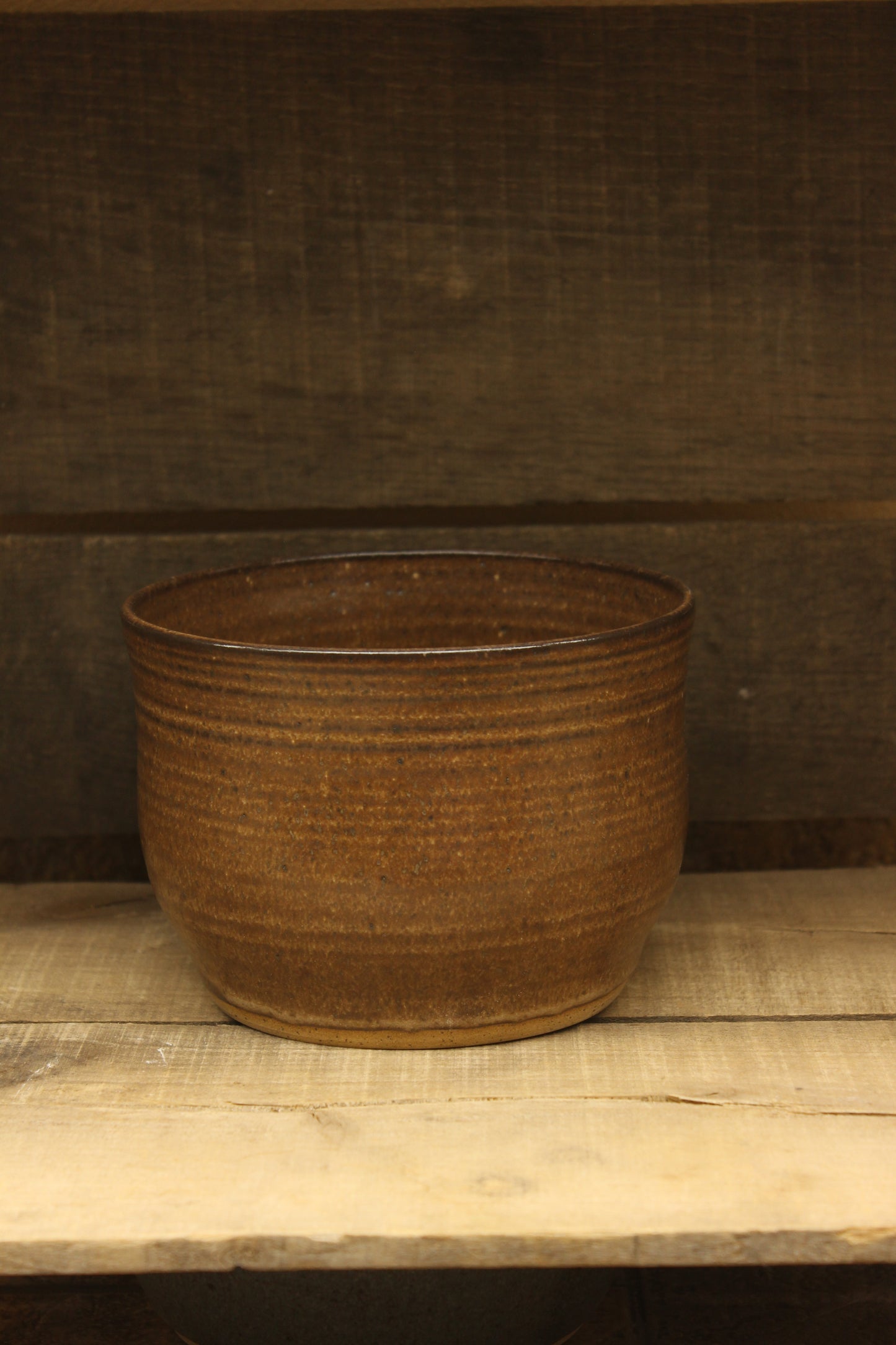 Brown ceramic bowl on a wooden surface