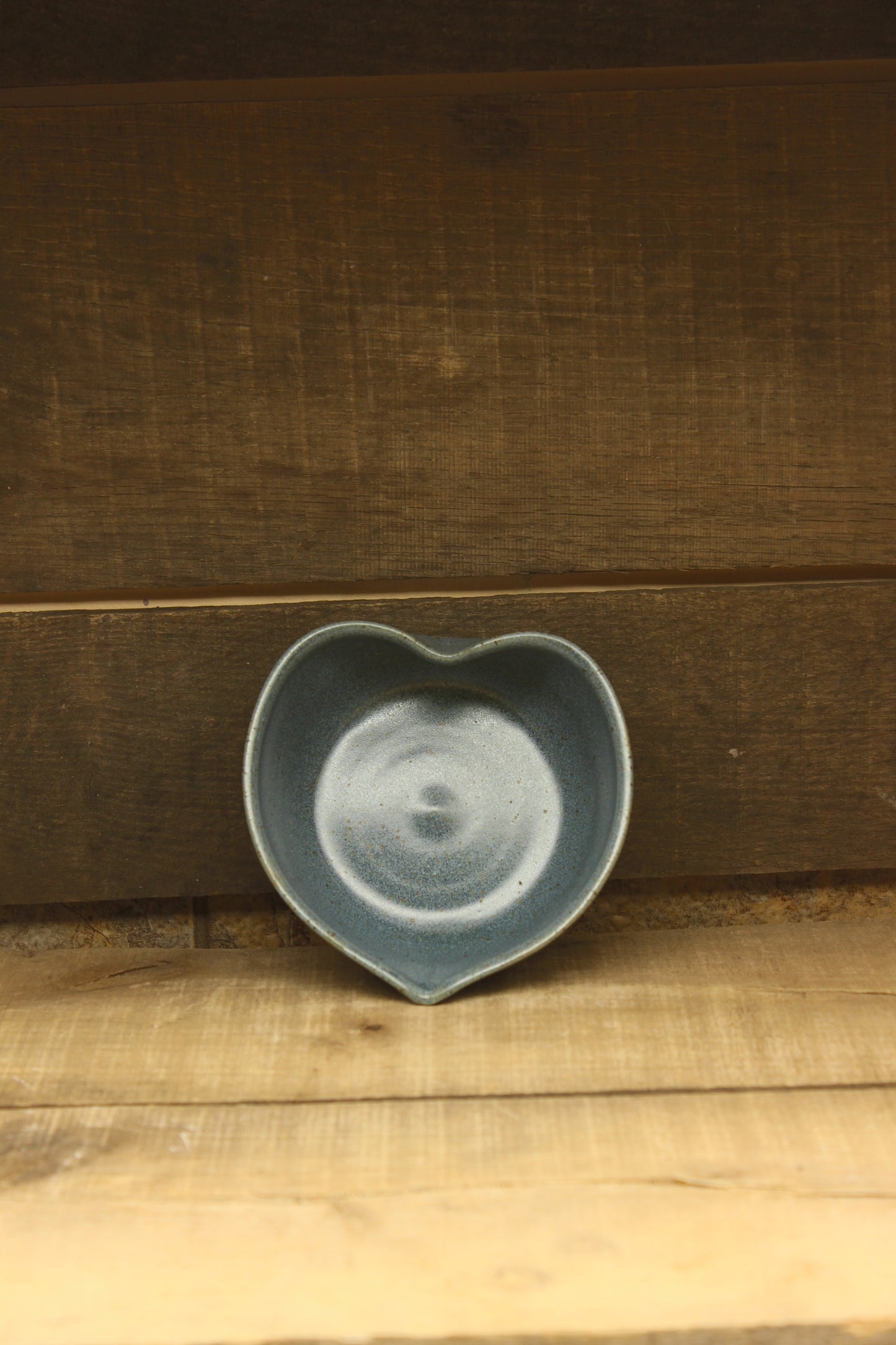 blue heart ceramic bowl on a wooden surface