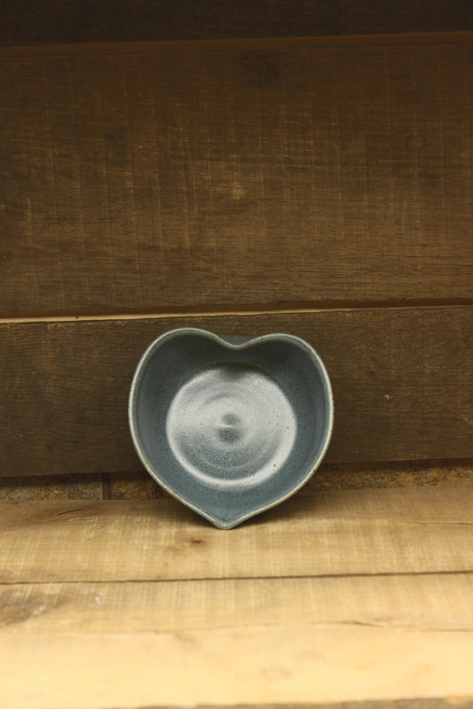 blue heart ceramic bowl on a wooden surface